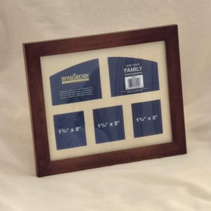 May include: A dark brown wooden multi-photo frame with a cream-colored mat. The frame has five openings, three of which are labeled "1 3/4" x 2". The top right opening reads "FOR YOUR FAMILY PHOTOGRAPH". The top left opening reads "HOMETRENDS".
