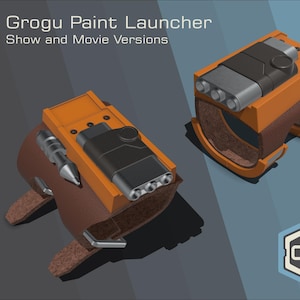 Könnte beinhalten: Zwei Grogu Paint Launcher, Show- und Movie-Versionen, werden gezeigt. Die Launcher sind orange und schwarz mit braunen Lederriemen. Der Text "Grogru Paint Launcher Show and Movie Versions" steht oben. Das CGS Props-Logo befindet sich unten rechts.