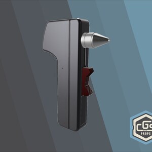 Peut inclure: Un appareil portable noir avec une pointe argent&eacute;e et un levier rouge. L'appareil est fabriqu&eacute; par CGS Props.