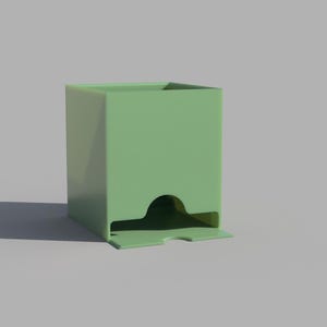 May include: A green plastic card holder with a slot for dispensing cards. The holder has a rectangular shape with a rounded opening on the front.