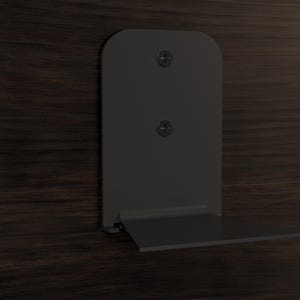May include: A black metal shelf bracket with two screws attached to a dark wood surface. The shelf bracket has a fold-down shelf.