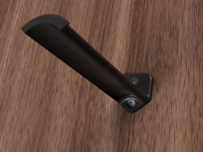 May include: Black metal shelf bracket with a curved design. The bracket is mounted to a wood surface with two screws.