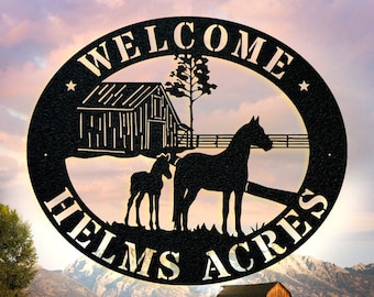May include: Black metal sign with the words "Welcome Helms Acres" in a circle. The sign features a silhouette of a barn, a tree, and two horses.