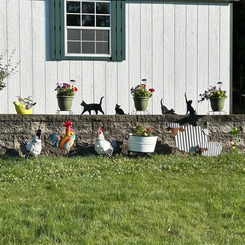 a group of chickens and chickens in front of a house