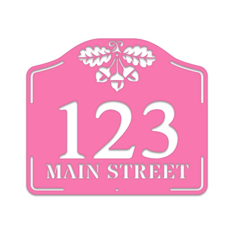 May include: Pink metal house number sign with white lettering. The sign features the number 123 and the street name "MAIN STREET" with an acorn and oak leaf design at the top.