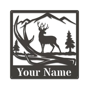 May include: Black metal silhouette of a deer standing in a mountain landscape with antlers in the foreground. The text "Your Name" is below the image.