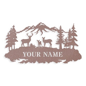 May include: A metal wall art piece featuring a mountain range with three deer, two adult deer and a fawn, standing in front of a forest. The text "YOUR NAME" is displayed below the deer.