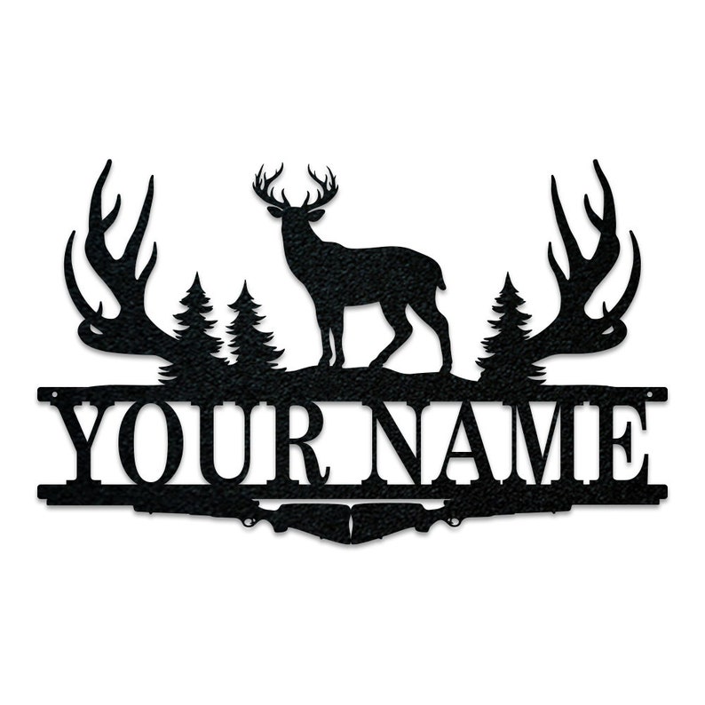 May include: Black metal silhouette of a deer with antlers, standing in front of two pine trees. The deer is facing right. The antlers are curved and point to the left and right. The deer is standing on a black metal base with the text "YOUR NAME" in white letters.