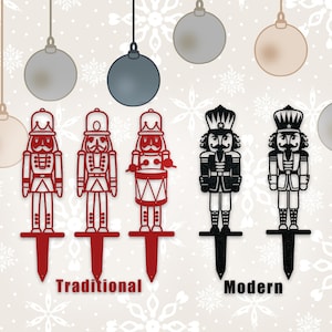 May include: Three red nutcracker silhouettes with a drum, a sword, and a rifle, and two black nutcracker silhouettes with a drum and a sword. The silhouettes are on stakes and the text "Traditional" and "Modern" is below the silhouettes.