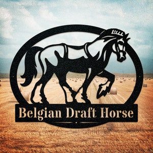May include: Black metal silhouette of a Belgian Draft Horse in a circular frame with the text "Belgian Draft Horse" below. The silhouette is set against a background of a field of hay bales.