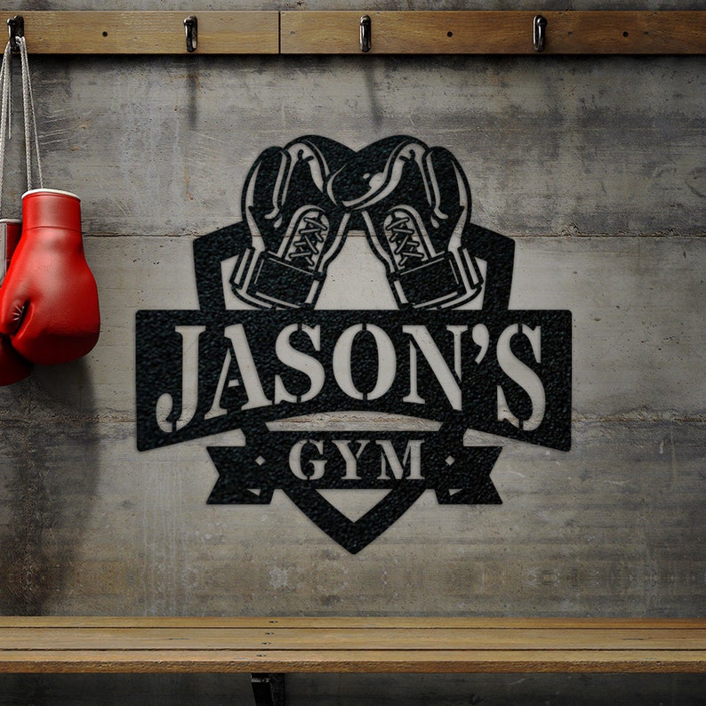 May include: Black metal sign with a boxing glove design and the text "JASON'S GYM".