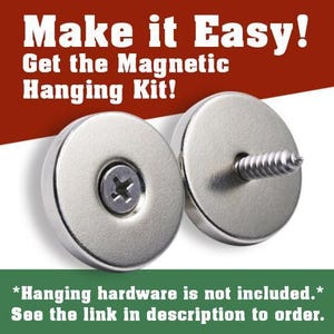 The image is an advertisement for a magnetic hanging kit, featuring a pair of silver-colored magnets with screws and a screwdriver. The text on the image reads "Make it Easy! Get the Magnetic Hanging Kit!" and includes a warning that "Hanging hardware is not included. See the link in description to order."