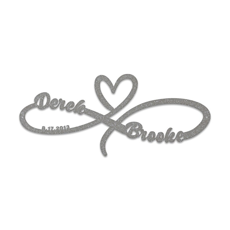 May include: Silver glitter infinity symbol with a heart in the centre. The names "Derek" and "Brooke" are written on either side of the symbol, with the date "8.17.2013" below "Derek".