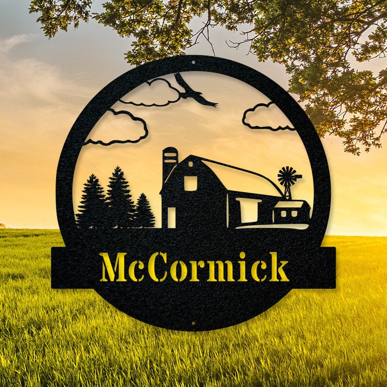 May include: Black metal round sign with a silhouette of a barn, trees, and a windmill. The sign has a yellow banner at the bottom with the name "McCormick".