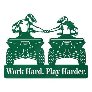 May include: Green metal silhouette of two people riding quad bikes, holding hands, with the text "Work Hard. Play Harder." below.