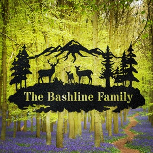 May include: Black metal silhouette of a mountain range with two deer and a fawn, two pine trees, and the text "The Bashline Family".
