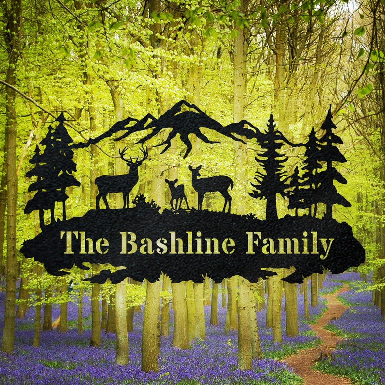 May include: Black metal silhouette of a mountain range with two deer and a fawn, two pine trees, and the text "The Bashline Family".