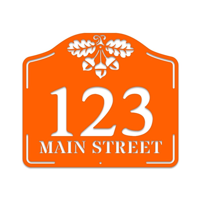 May include: Orange metal house number sign with an acorn design and the address 123 Main Street.