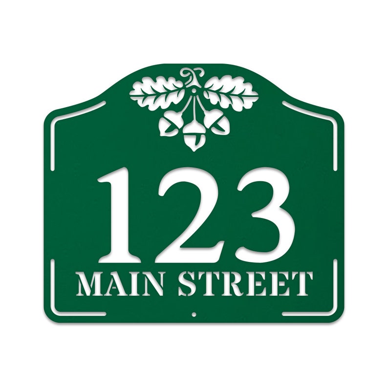 May include: Green metal house number sign with white lettering. The sign features an acorn and oak leaf design and the address 123 Main Street.