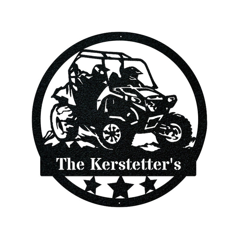 May include: Black metal silhouette of a side-by-side off-road vehicle with two figures inside. The vehicle is driving over a hill. The words "The Kerstetter's" are written below the vehicle in a white banner.