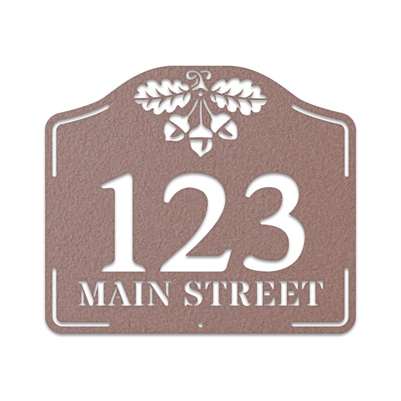 May include: A brown metal house number sign with an acorn and oak leaf design. The number 123 and the text "MAIN STREET" are cut out in white.