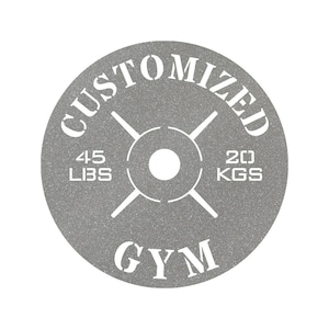 May include: A gray weight plate with a white design. The plate says "CUSTOMIZED" at the top, "GYM" at the bottom, and "45 LBS" and "20 KGS" on either side.