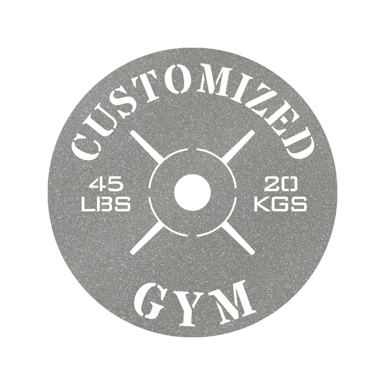 May include: A gray weight plate with a white design. The plate says "CUSTOMIZED" at the top, "GYM" at the bottom, and "45 LBS" and "20 KGS" on either side.