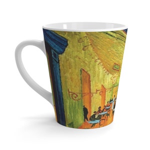 May include: A white ceramic latte mug with a colorful image of a cafe scene. The image is a painting with a yellow, green, blue, and orange color scheme. The scene depicts people sitting at tables in a cafe.