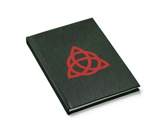 May include: A dark green journal with a red triquetra symbol on the front cover.
