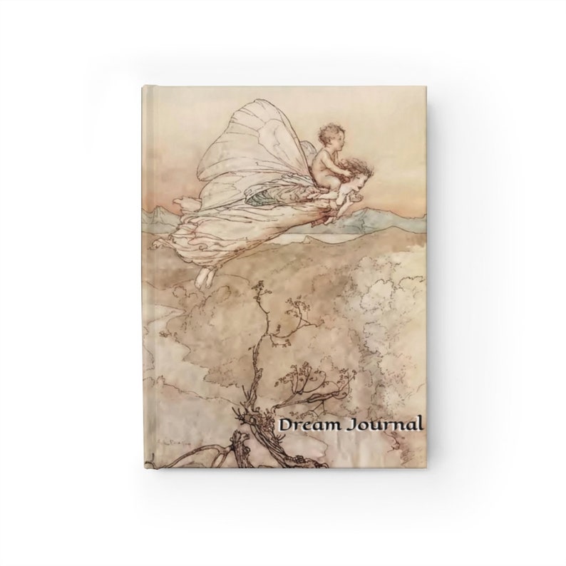 May include: A vintage illustration of a fairy with large wings flying through the air with a small child riding on her back. The fairy is wearing a long white dress and the child is wearing a simple tunic. The background is a soft, muted landscape with hills and trees. The text "Dream Journal" is printed at the bottom of the image.