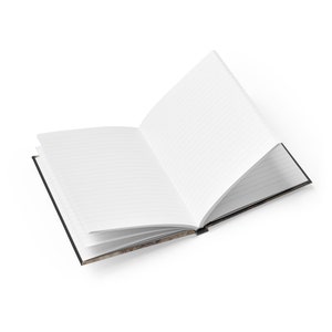 May include: An open lined notebook with a black cover. The cover has a vintage design with a map-like pattern.