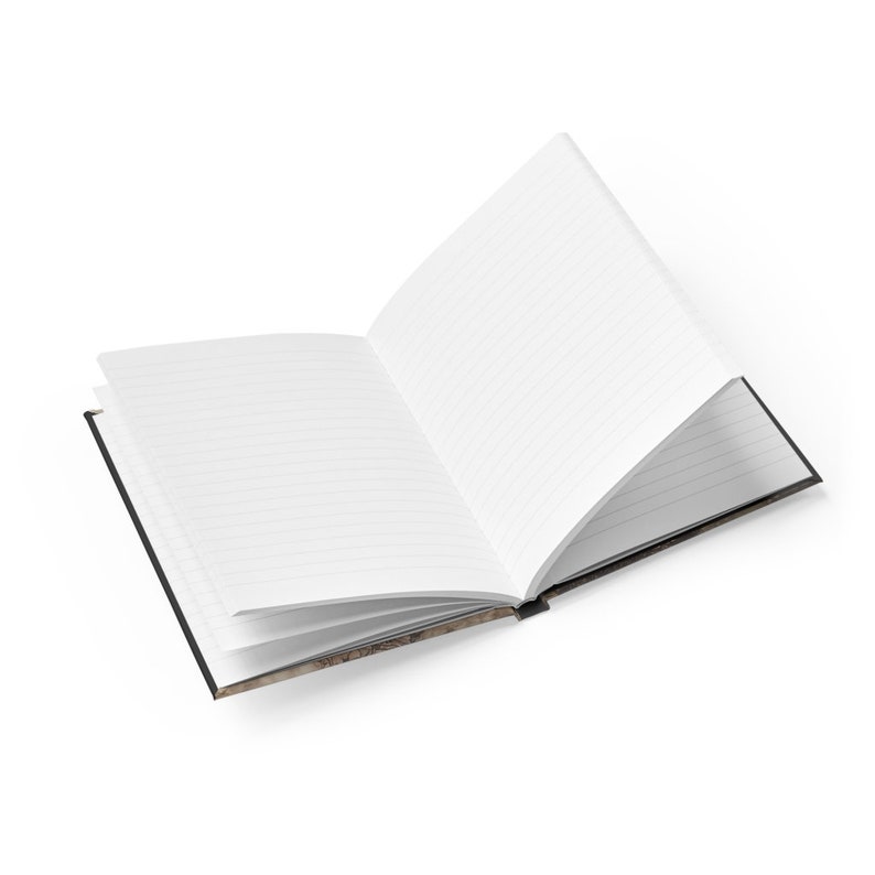 May include: An open lined notebook with a black cover. The cover has a vintage design with a map-like pattern.