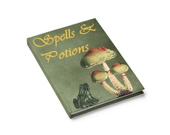 May include: A green journal with the text "Spells & Potions" in gold lettering. The cover features a mushroom with a red cap and a green frog.