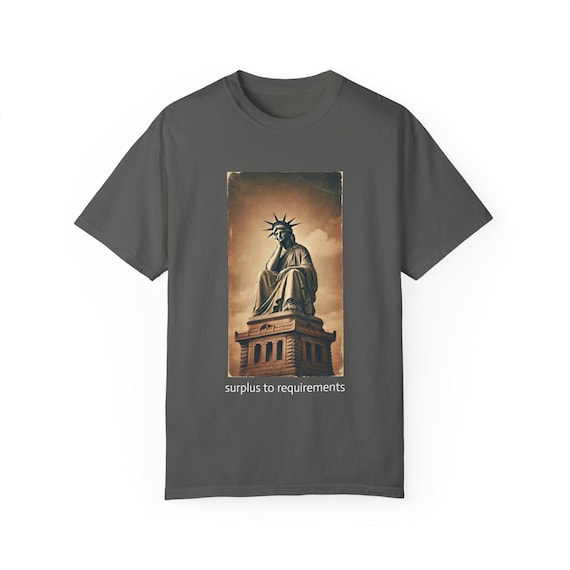 Surplus to requirements, Comfort Colors brand premium t-shirt. The Statue of Liberty has been fired. Liberty in Distress. Immigration art.