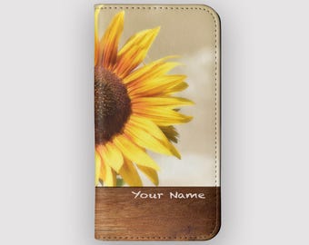 May include: A brown leather phone case with a sunflower design and the text "Your Name" on the bottom.