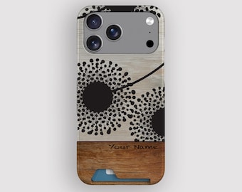 May include: A phone case with a wood grain design and a black floral pattern. The case has a brown lower section with the text "Your Name" and a blue card holder. The phone's camera lenses are visible at the top.