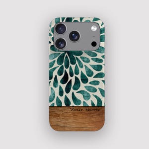 May include: A phone case with a teal floral design on a cream background. The top portion features a teal teardrop pattern, while the bottom has a wood-grain texture. The text "Your Name" is printed on the wood-grain section.