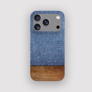 May include: A smartphone case featuring a blue denim design and a wooden base. The case has a camera module with three lenses and a flash. The text "Your Name" is printed on the wooden base.