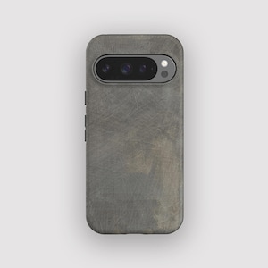 May include: A grey phone case with a textured, distressed appearance. The case has a camera cutout and side buttons. The overall design gives a rugged, industrial feel to the phone accessory.