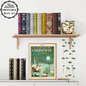 May include: A printable book art print featuring a vintage illustration of a snowy village scene with the text "The Night Before Christmas" and the author's name, Clement C. Moore. The print is framed and displayed on a shelf with a variety of books.