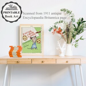 May include: A framed print of a vintage book page featuring an illustration of a mouse holding a cookie. The text on the page reads "If you give a mouse a cookie".