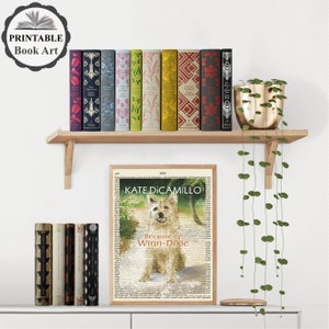 May include: A framed print of a book cover featuring a white dog with the title "Because of Winn-Dixie" by Kate DiCamillo. The print is on a shelf with a variety of colorful books and a hanging plant.