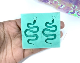 May include: A light blue silicone mold for making snake earrings. The mold has two snake shapes with a small circle at the top of each snake for attaching earring hooks.