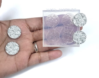 May include: A clear silicone mold with six round cavities for making resin crafts. The mold is shown with three silver glitter filled resin pieces.