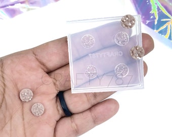 May include: Clear silicone mold with four round cavities for making resin earrings. The mold is shown with two finished resin earrings with a speckled design.