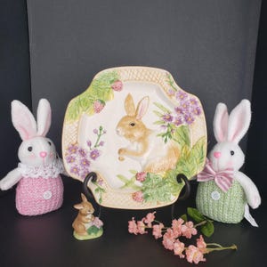 May include: A set of three ceramic mugs with a speckled, matte finish. The mugs are in shades of cream, light gray, and dark gray. Each mug has a simple, minimalist design, perfect for coffee or tea.