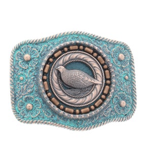 Puede incluir: Una hebilla de cinturón turquesa y cobre con un diseño ornamentado que presenta un pájaro plateado en un círculo.