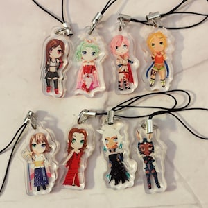 May include: A collection of eight acrylic charms featuring anime-style characters. Each charm has a unique character design with vibrant colors and attached to a black lanyard with a silver clasp. The characters are in various poses and outfits.