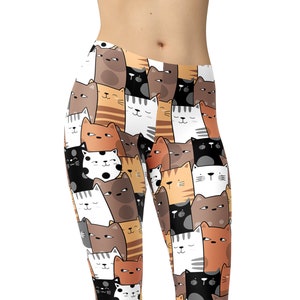 May include: A pair of black leggings with a colorful pattern of cartoon cats. The cats are in various colors, including brown, orange, white, and black. The leggings are a comfortable and stylish choice for everyday wear.