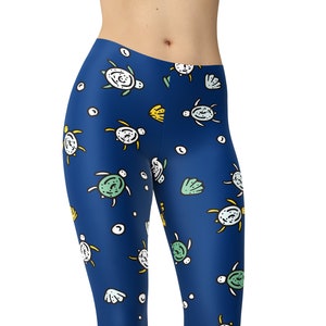 May include: Blue leggings with a pattern of white and green sea turtles and seashells.